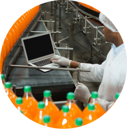 male-worker-using-laptop-amidst-production-line-juice-factory 3